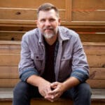 Jeremy on Podcasts - Self Portrait of Agency Owner of Shine Insurance Sitting on a Bench Outside